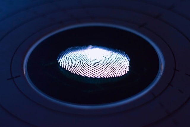 A digital thumb print in a blue circle to symbolize multifactor authentication (MFA)