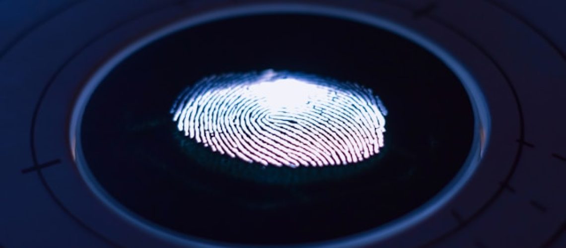 A digital thumb print in a blue circle to symbolize multifactor authentication (MFA)